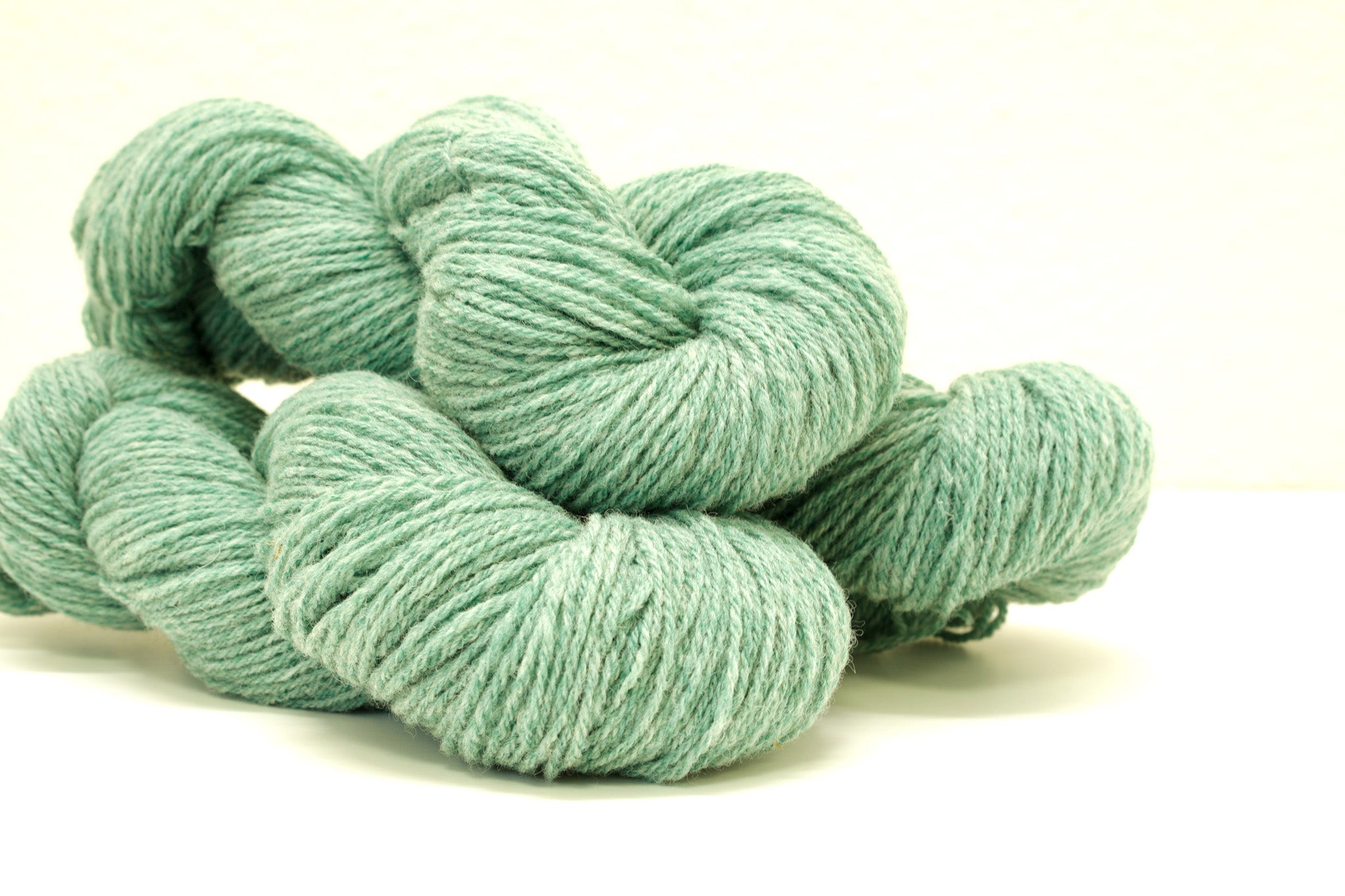 Green melange color Merino and Suffolk wool yarn blend