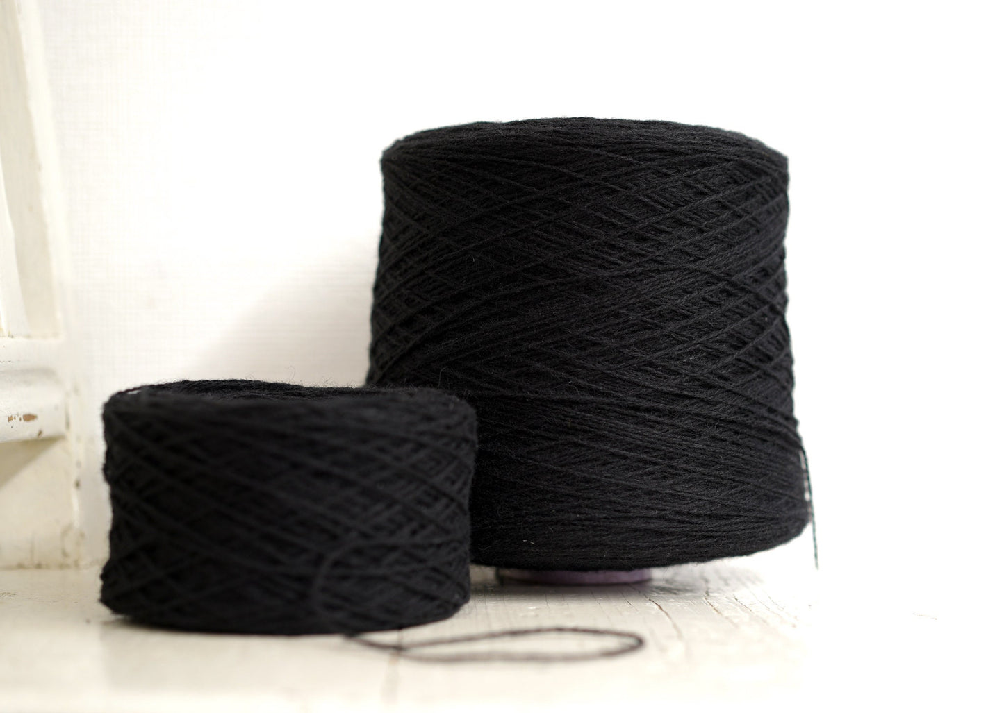 Black fingering wool yarn in cones | black-fingering-wool-yarn-in-cones