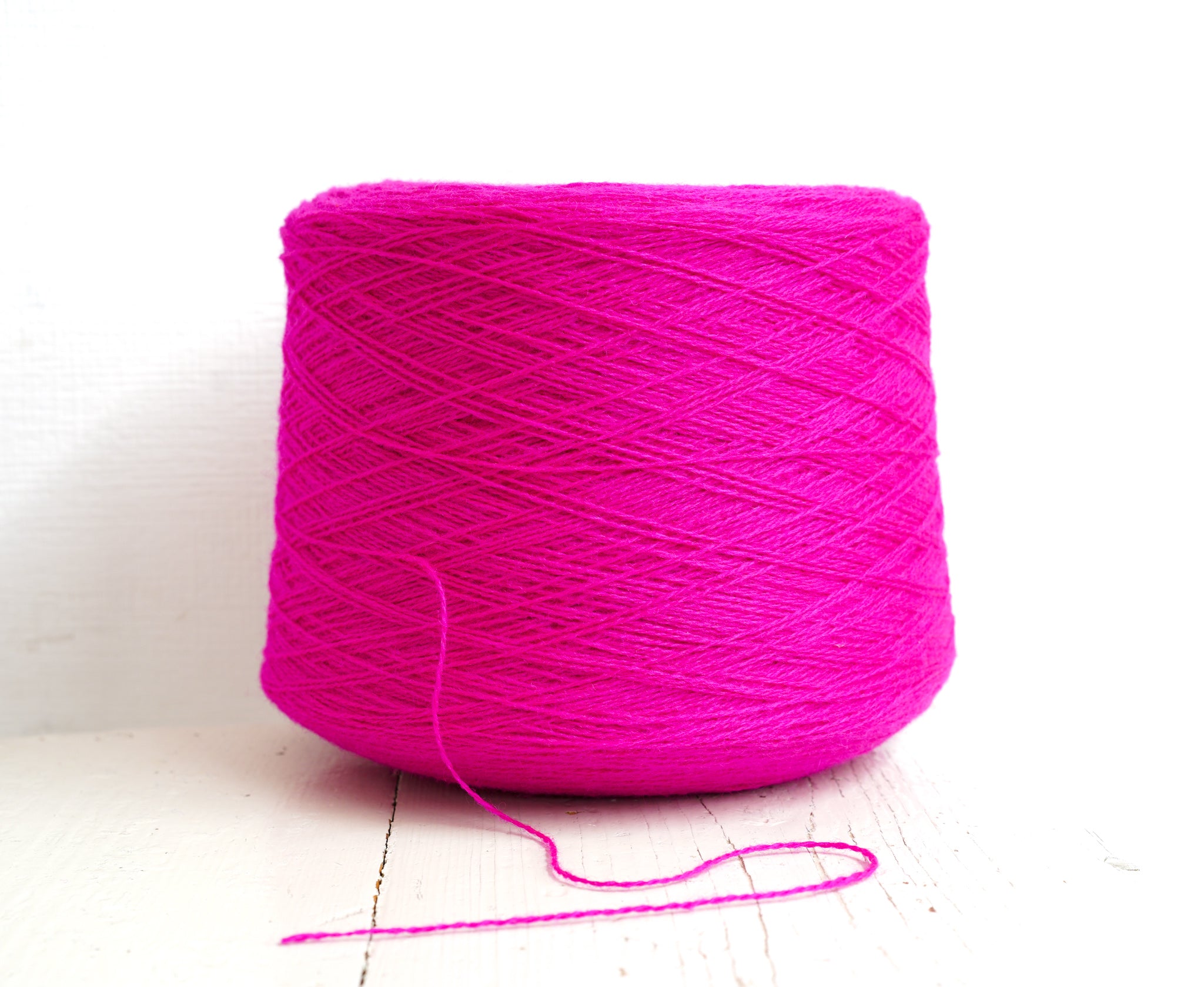 Neon pink New Zealand wool in a cone - 107