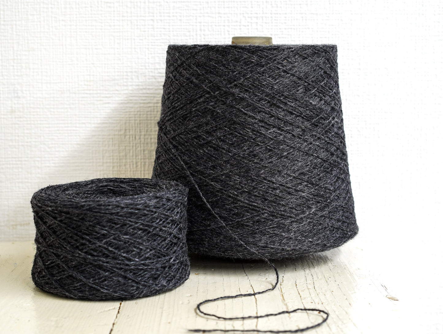 Dark grey fingering wool yarn in cones | dark-grey-fingering-wool-yarn-in-cones