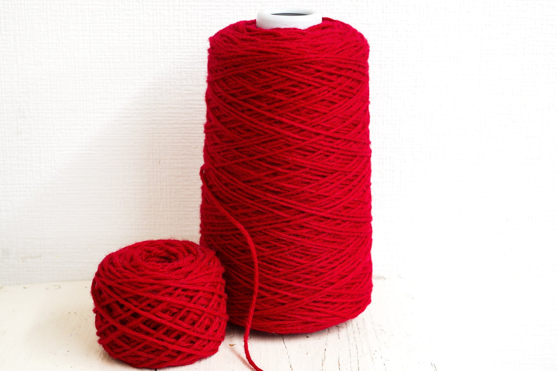 Bright red wool yarn in cones