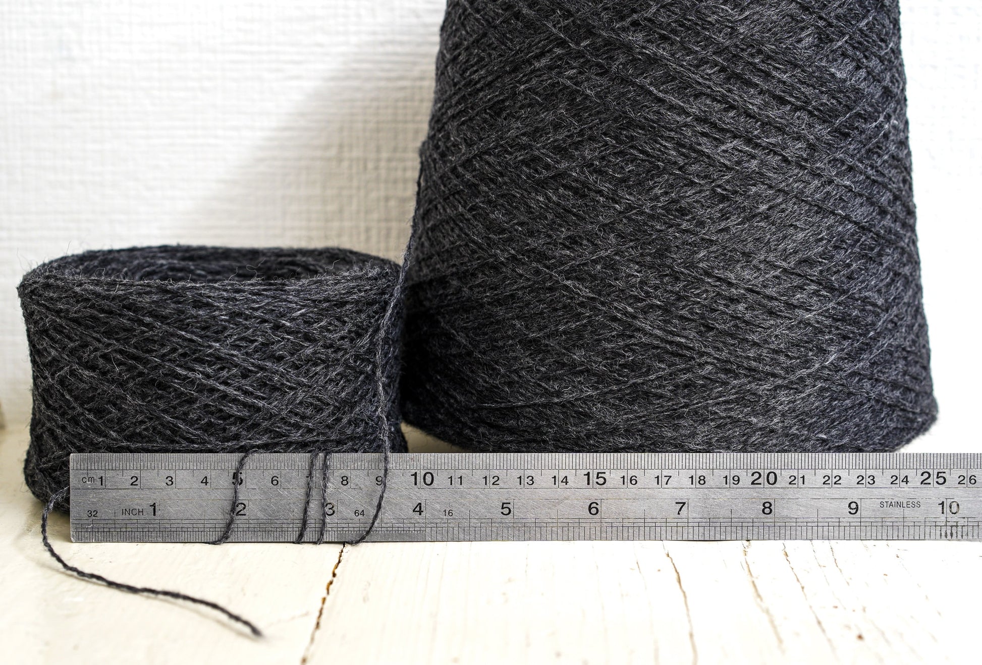 Dark grey fingering wool yarn in cones | dark-grey-fingering-wool-yarn-in-cones