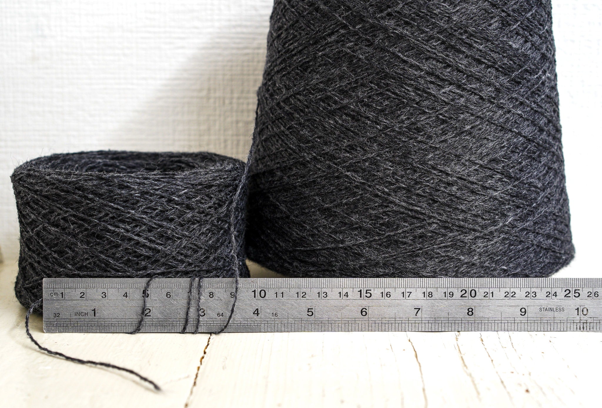 Dark grey fingering wool yarn in cones | dark-grey-fingering-wool-yarn-in-cones