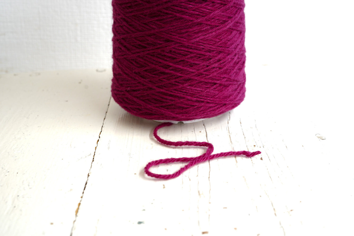 Bright rose wool yarn in a cone | bright-rose-wool-yarn-in-a-cone